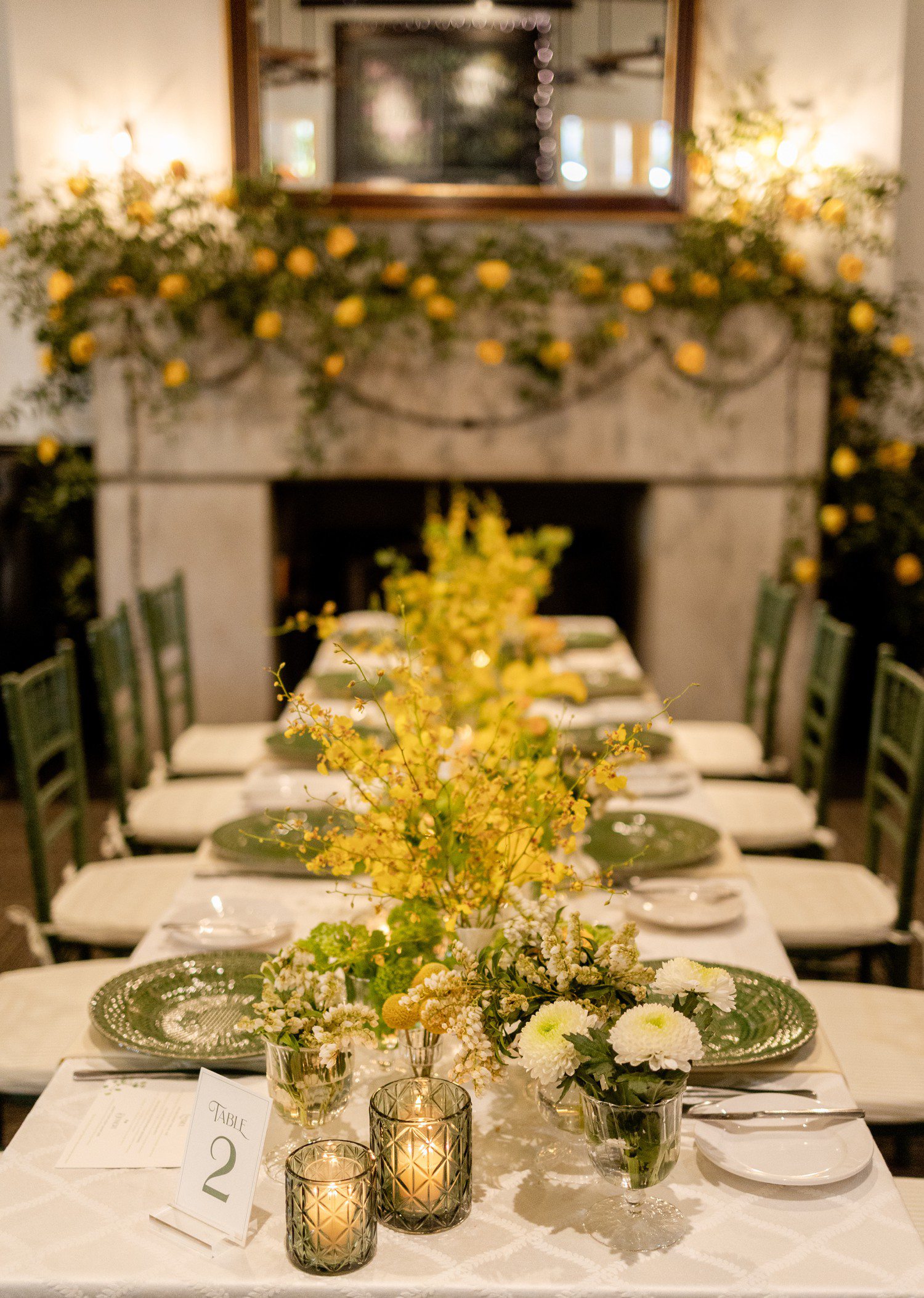 Yellow flowers decorating table for rehearsal dinner at Ousie's in Houston.