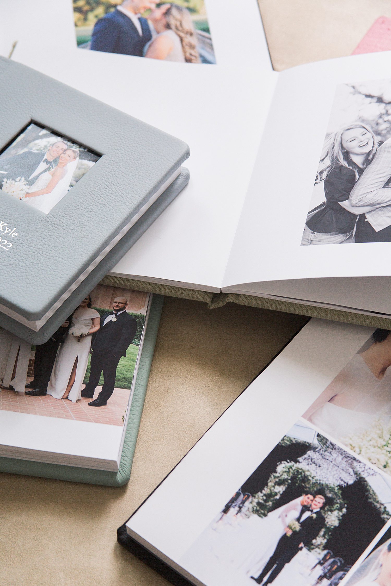 Open wedding photo books on table