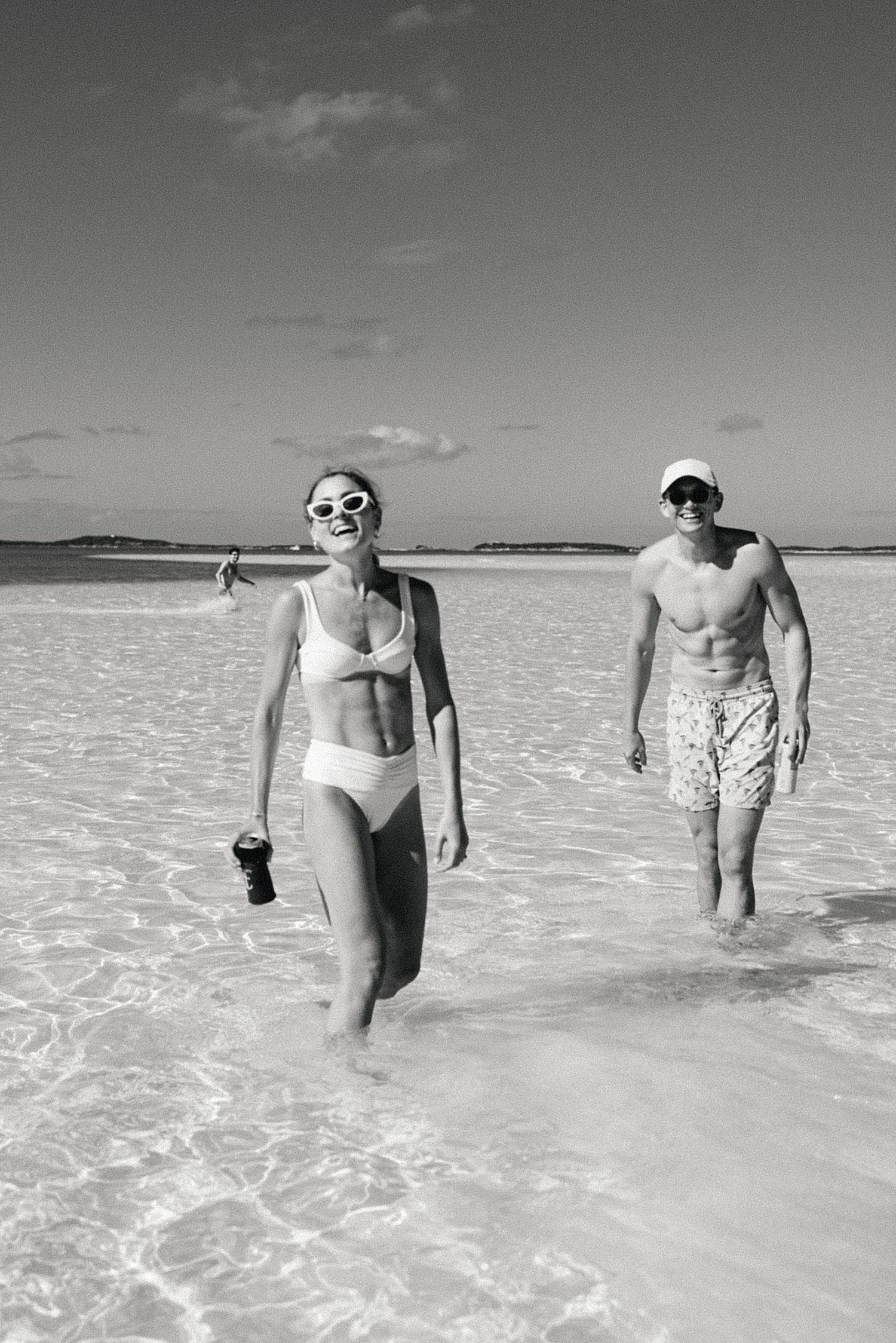 Bride & groom walking in the water in the Bahamas