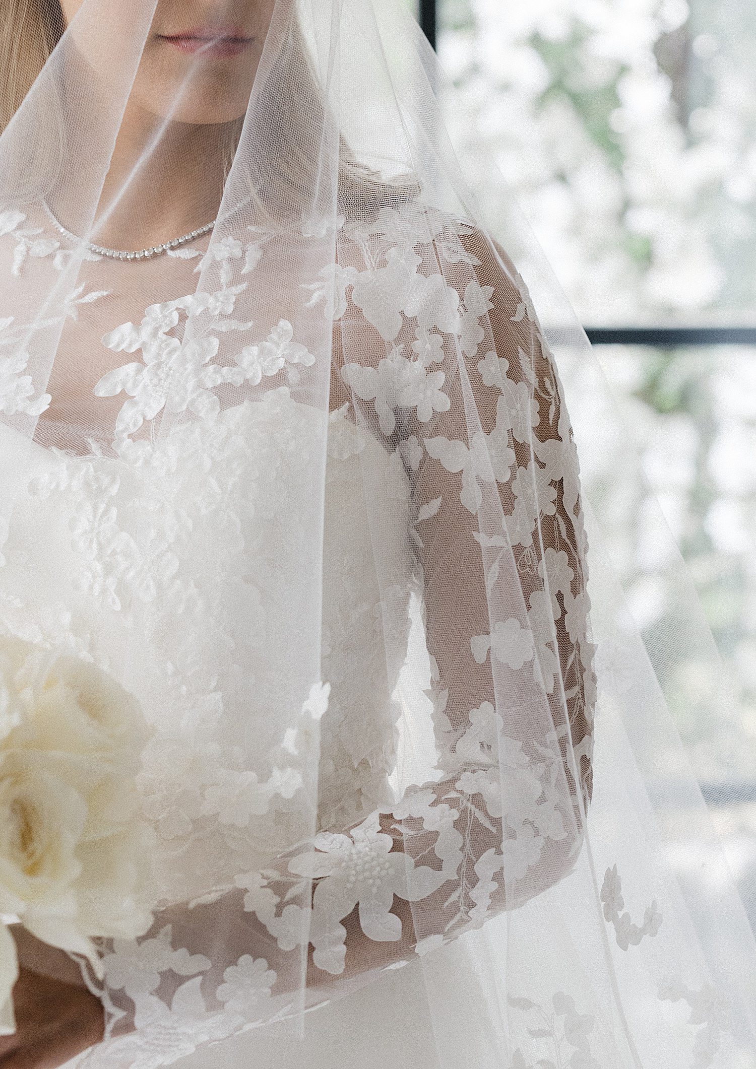 Close up of bride's gown and bouquet