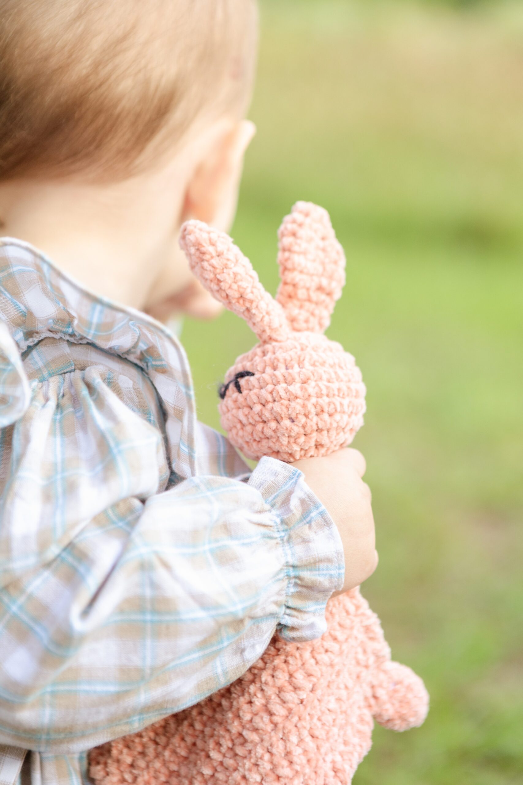 Baby girl holding stuffed rabbit