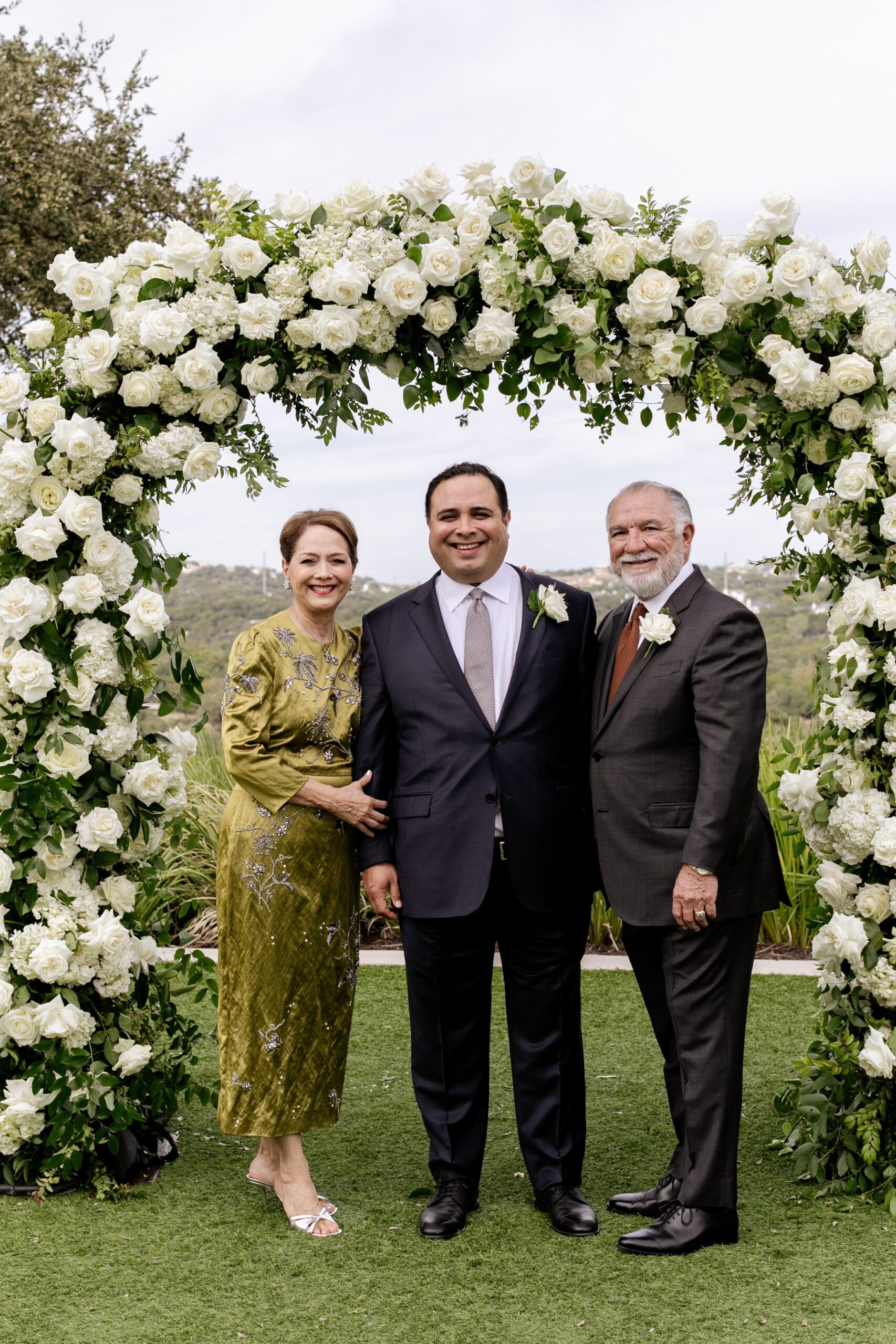 Groom with his parents at wedding