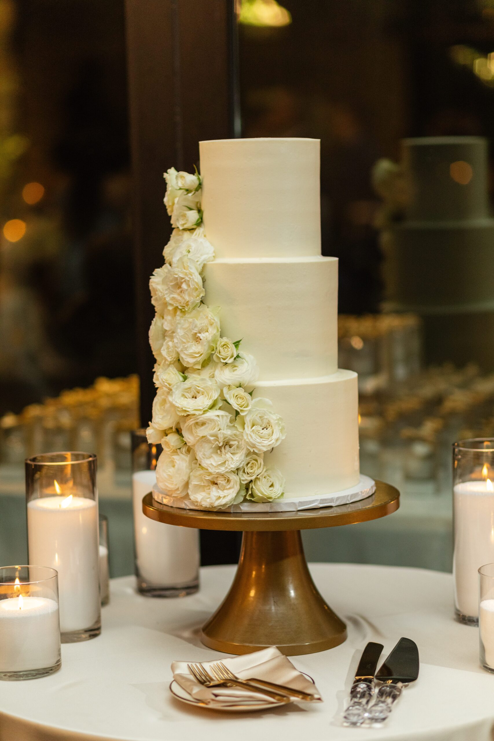 Three tiered white wedding cake with flowers