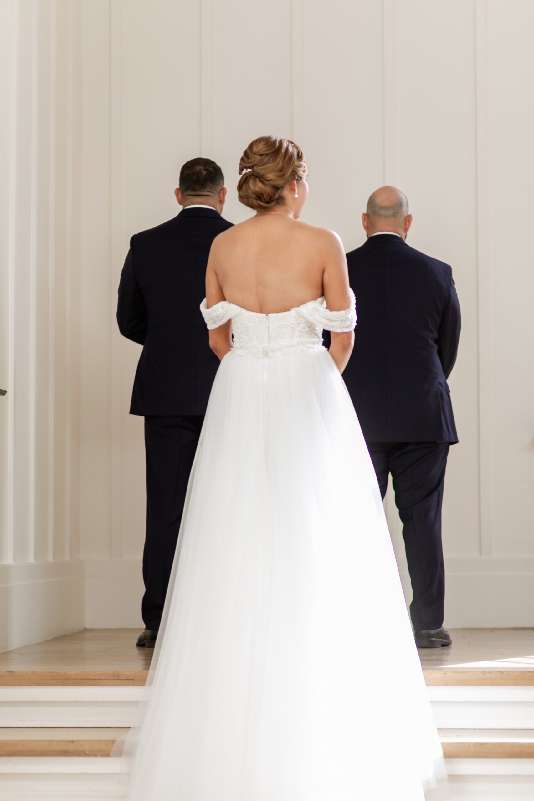 Bride waiting for first look with her two brothers