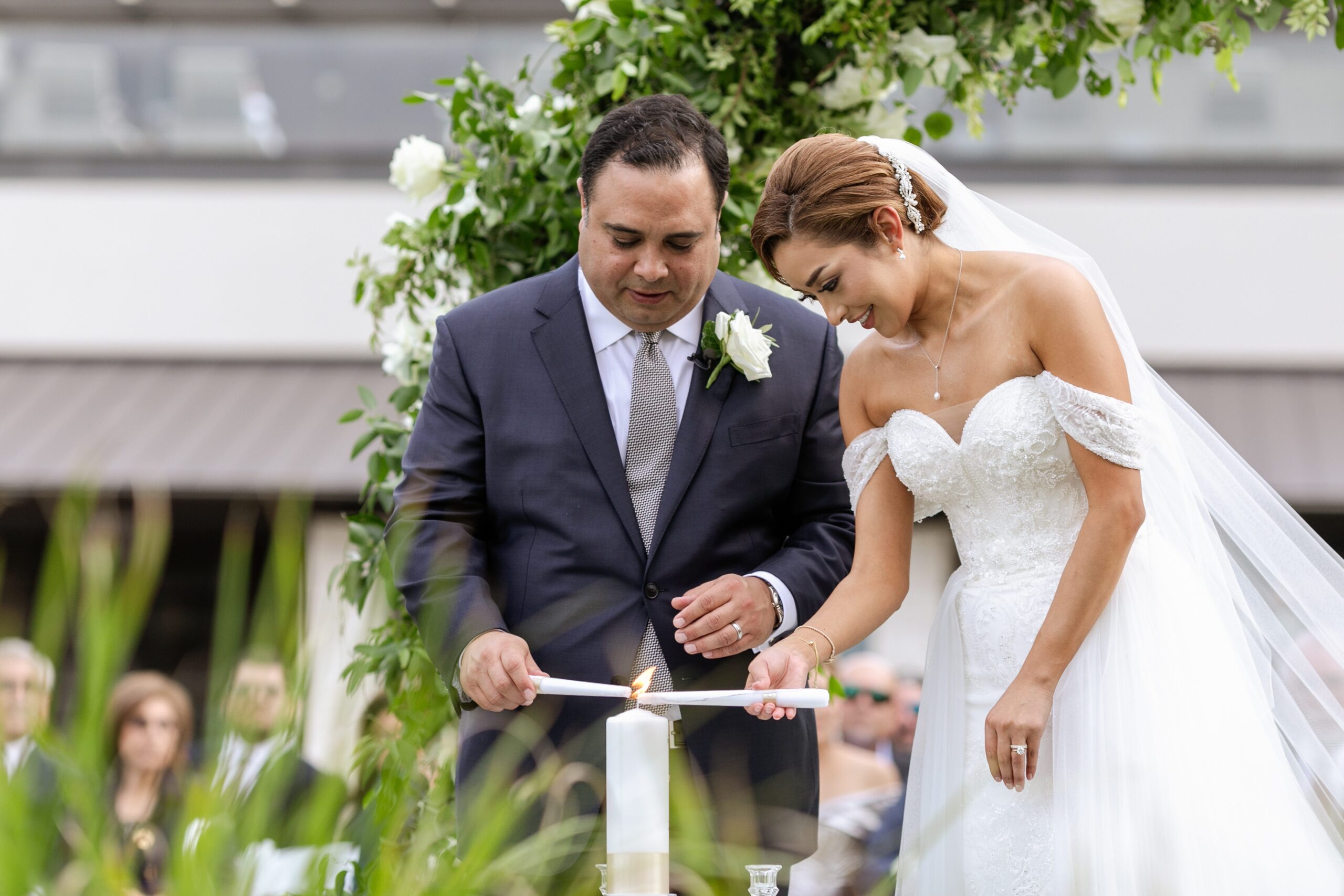 Couple lighting unity candle during wedding