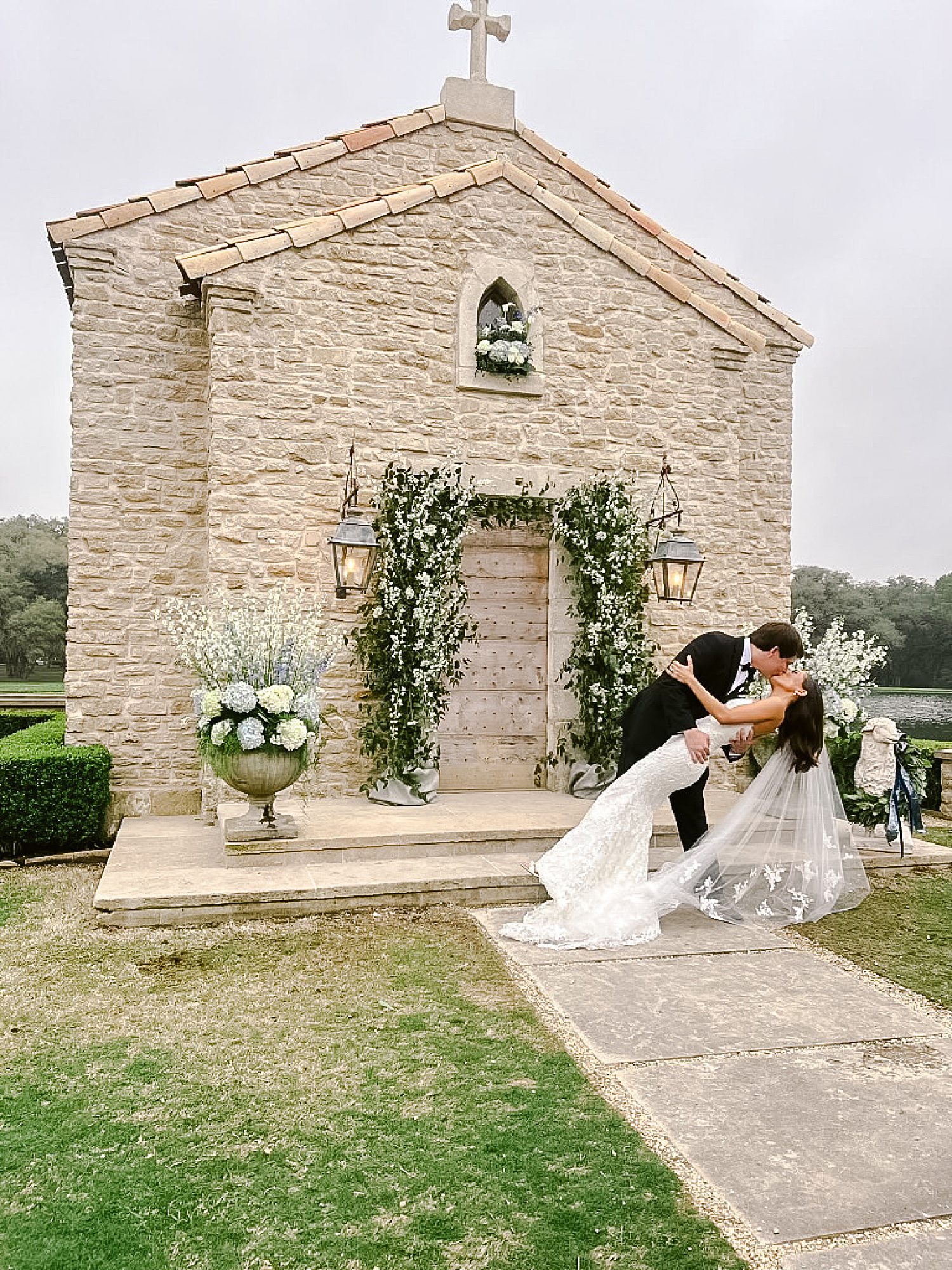 Couple kissing in front of chapel