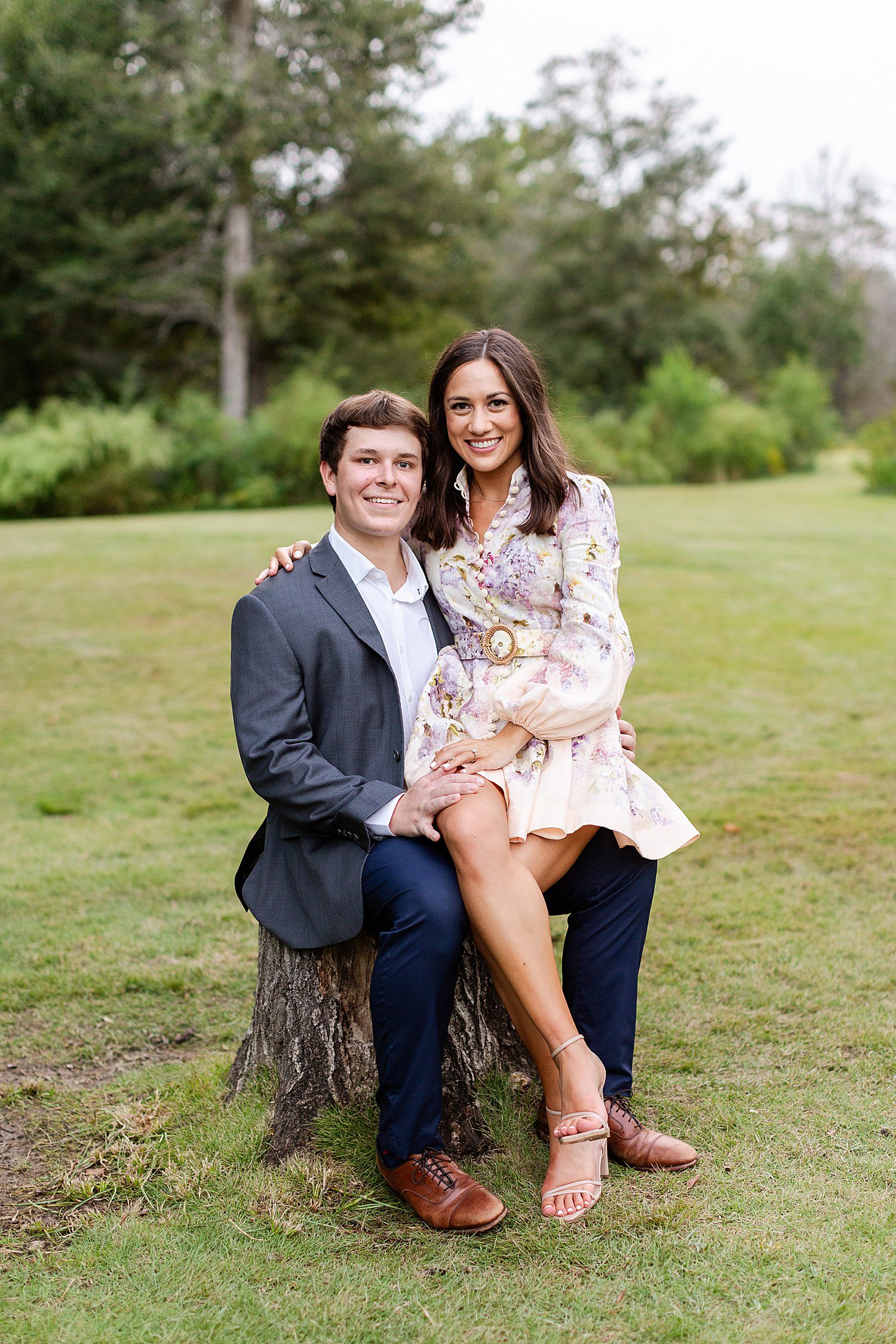 Woman sitting on her fiancé's lap for engagement photos