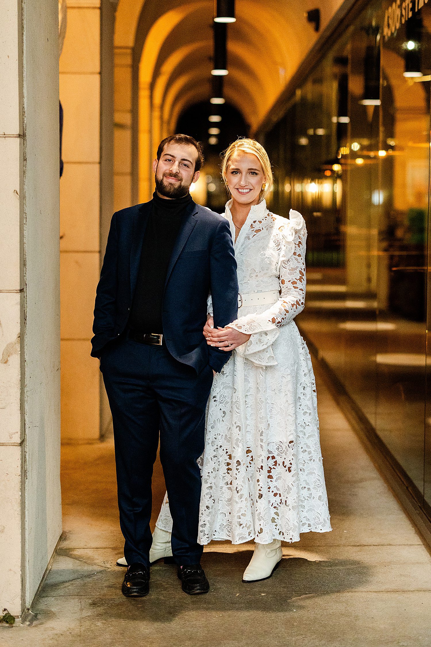 Engaged couple looking at the camera and smiling