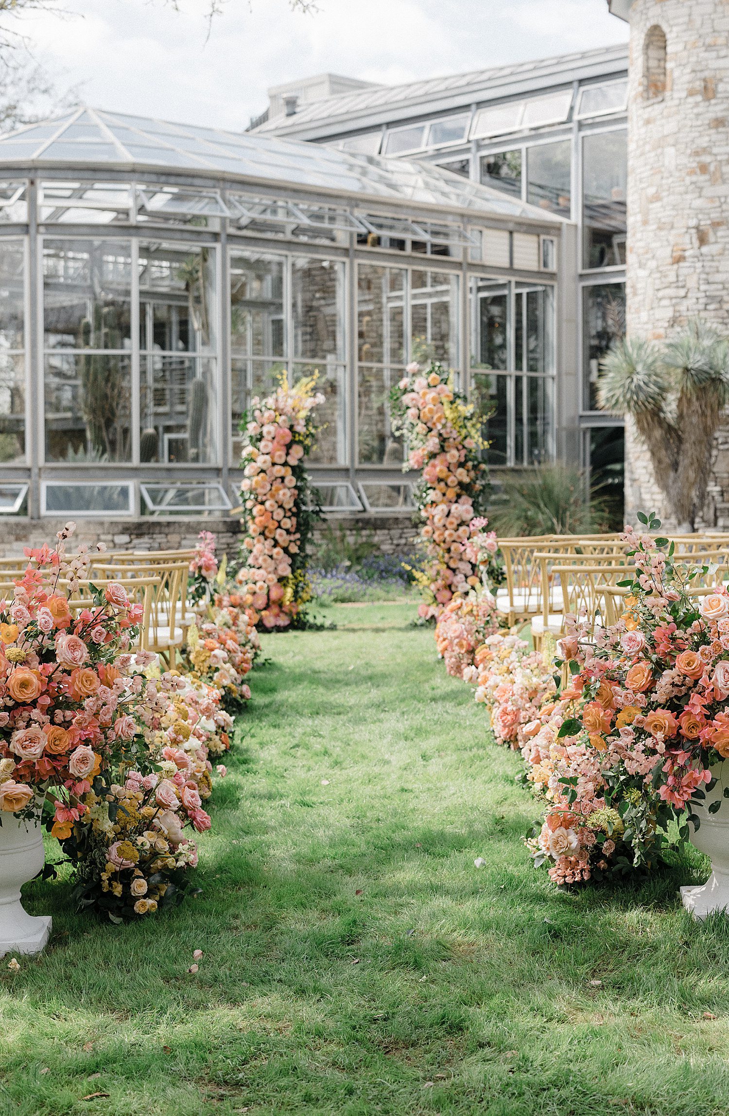 Colorful floral arch at altar at The Greenhouse at Driftwood wedding