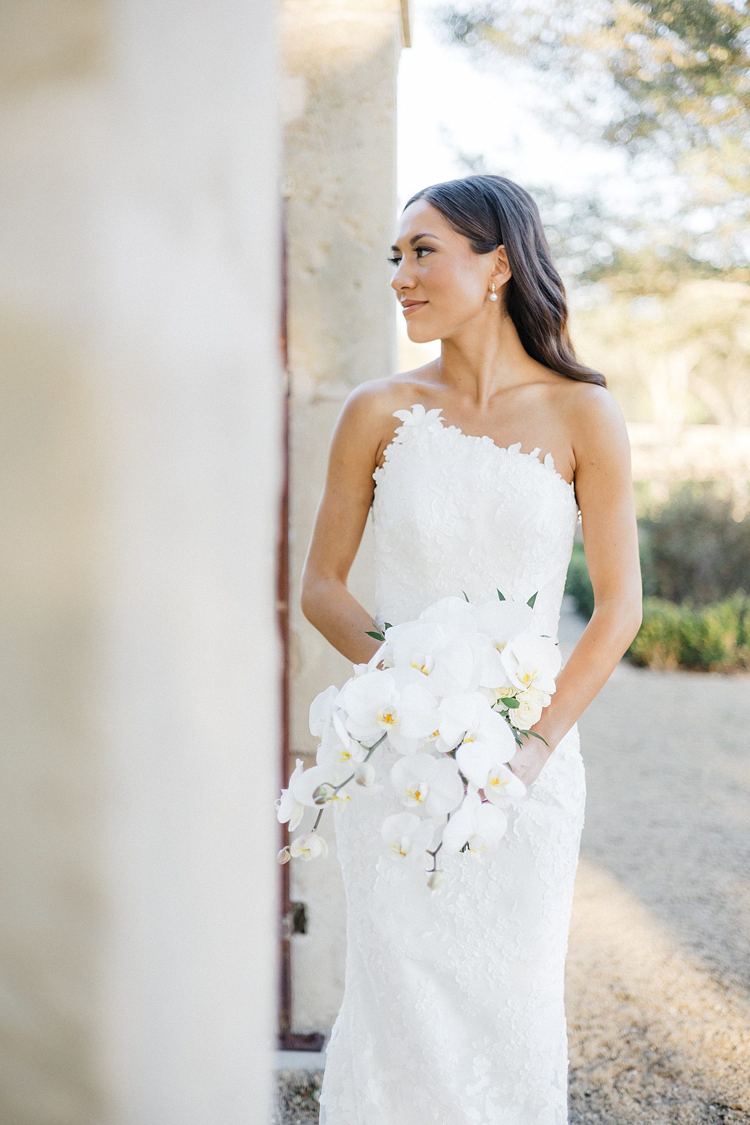 Bride holding bouquet of lillies