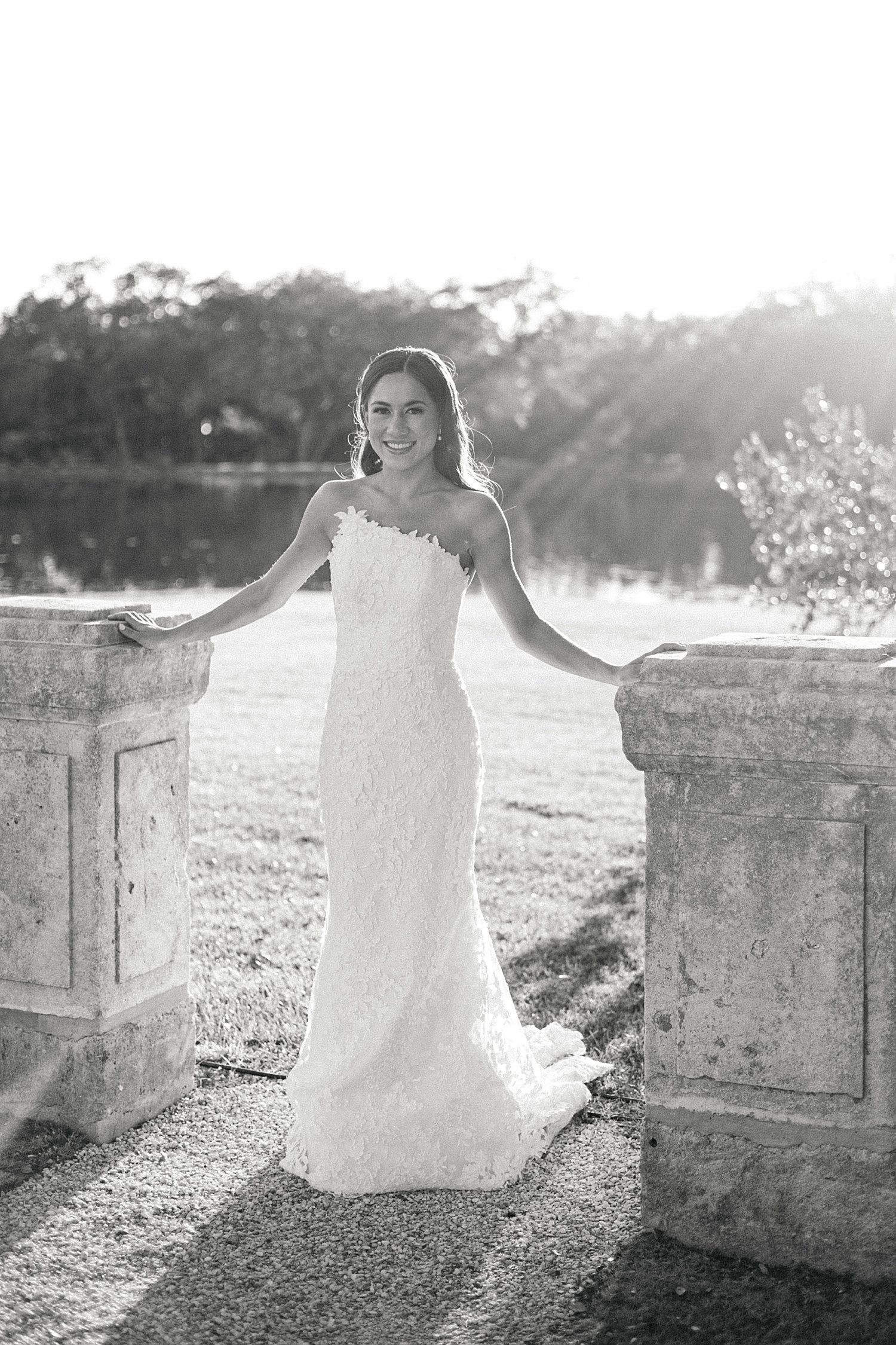 Bride in front of lake at bridal photoshoot at Houston Oaks Country Club