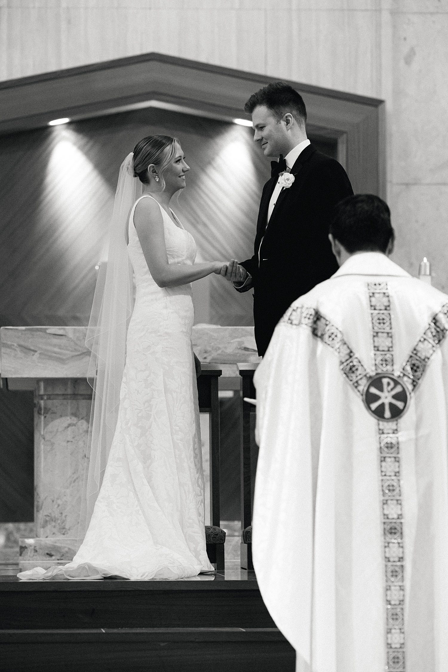 Bride and groom exchanging vows in Catholic mass