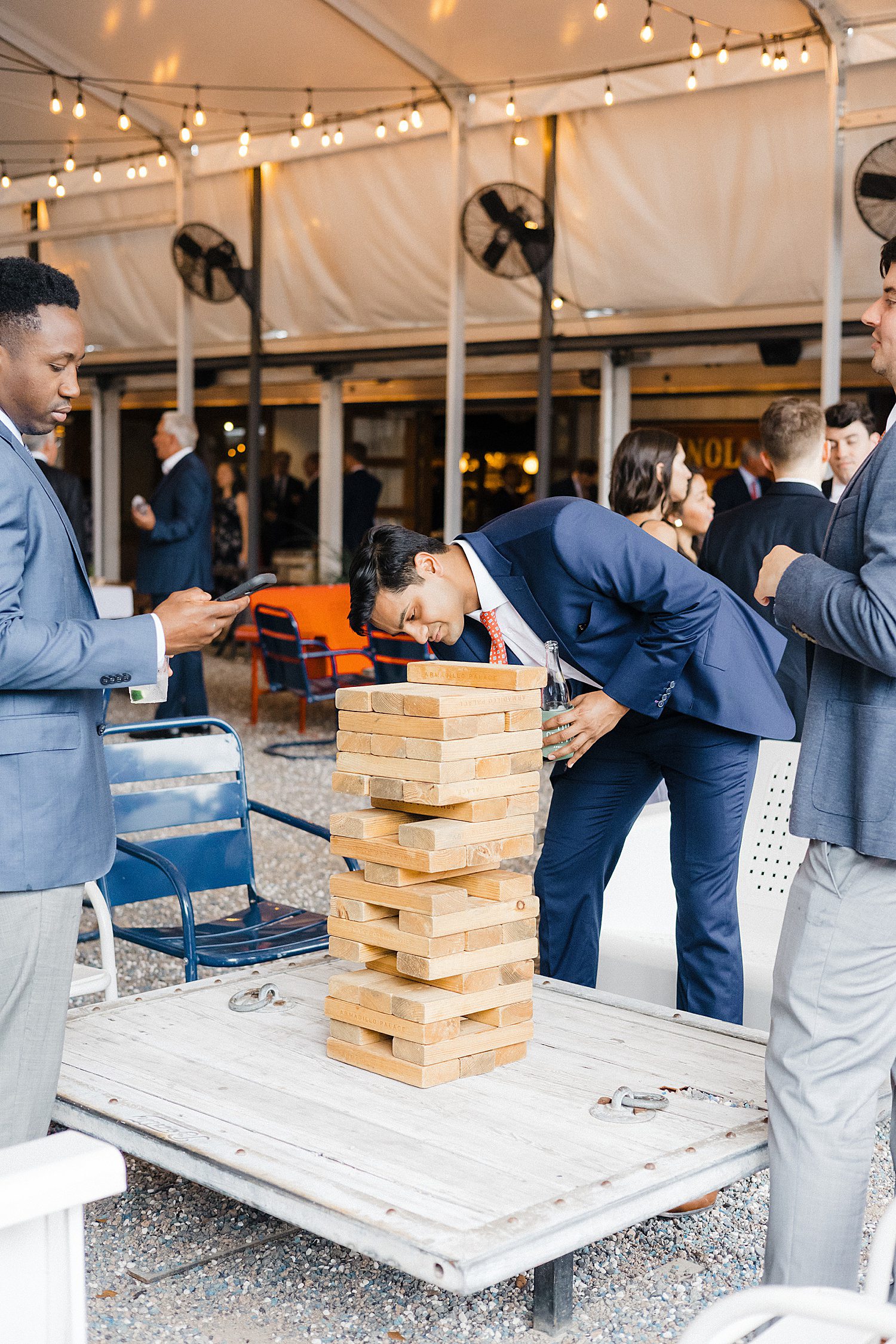 Wedding guests playing giant Jenga at Armadillo Palace in Houston