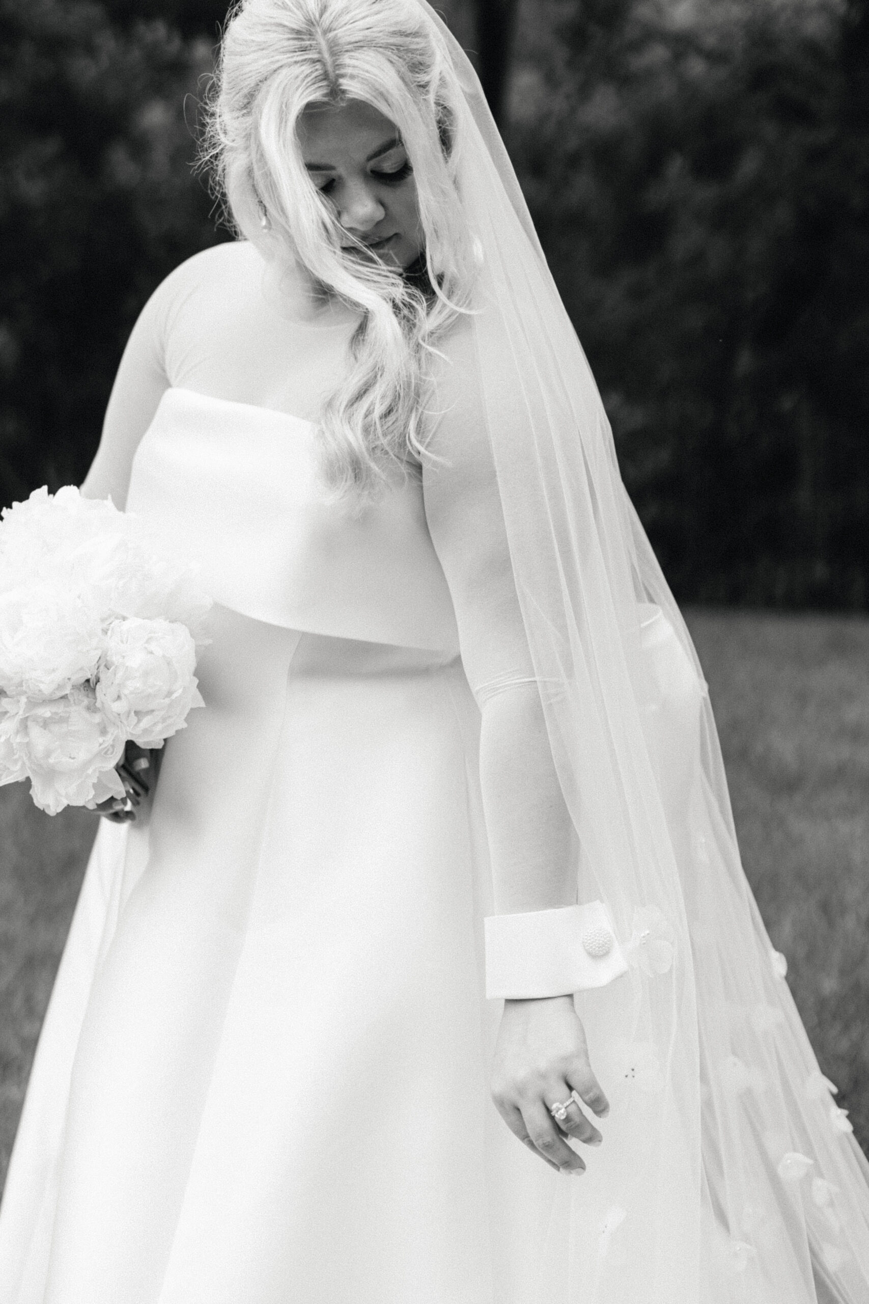 Bride with her white floral bouquet wearing her veil