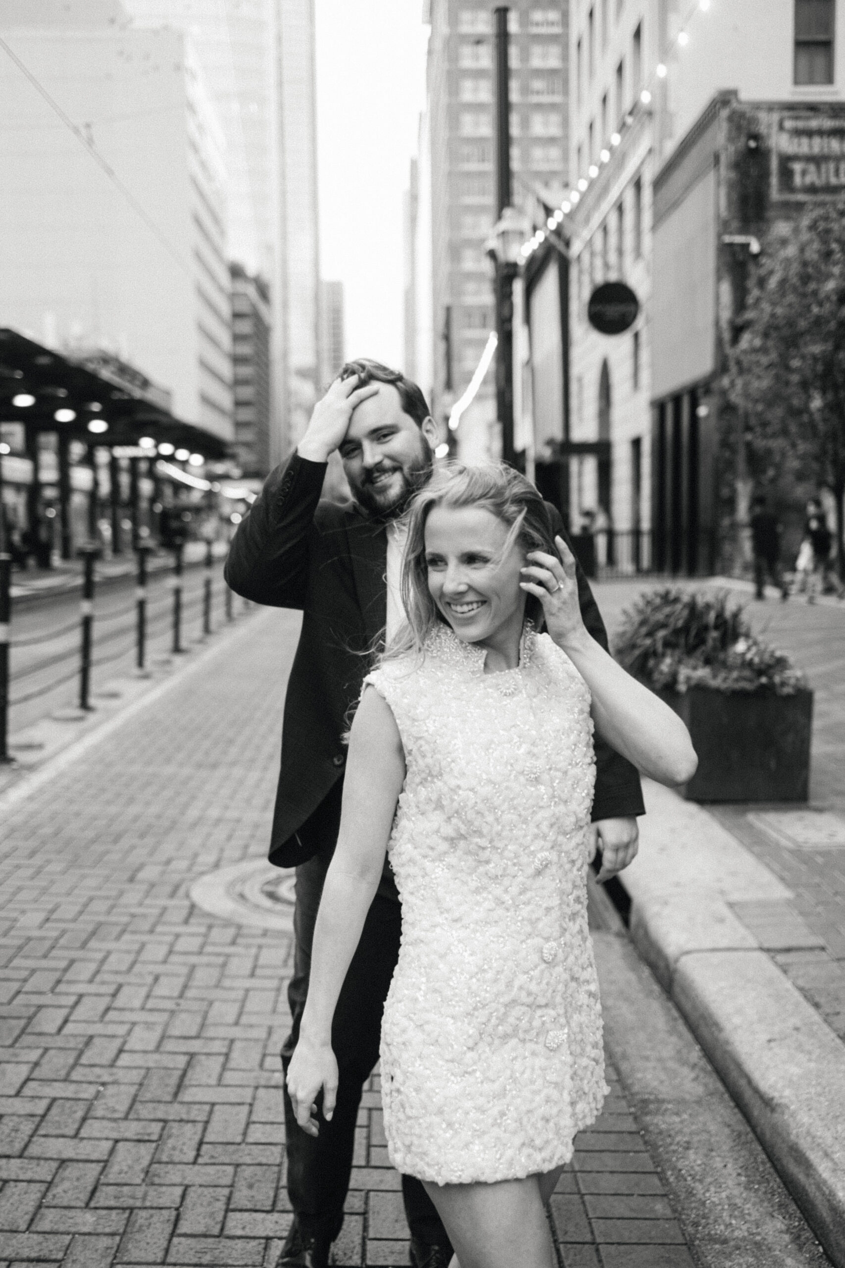 Engaged couple walking down street in downtown Houston